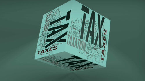 A cube with tax written on it in different typefaces.