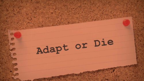a piece of paper with adapt or die on it