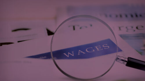 A magnifying glass that highlights the word wages.