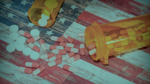 Prescription drugs spilling out onto the American flag