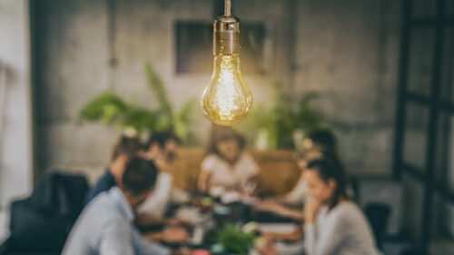A lightbulb over a meeting table