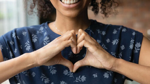 A woman making a heart with her hands