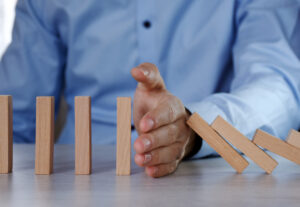 Man with blocks stopping them from falling