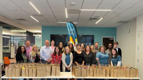 Holmes Murphy Dallas Employees standing together at a volunteering event.