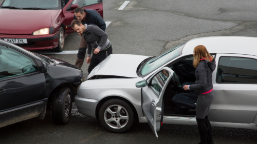 two cars hit each other and the drivers are talking