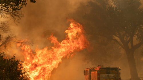 A fire truck driving to a fire